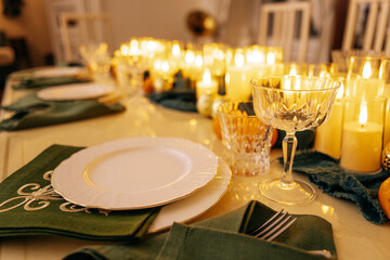 A cozy stylish living room with a covered table and a decorated Christmas tree with a garland.