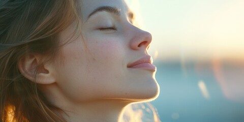 A woman in a serene pose, possibly yoga or meditation, with sunlight streaming through her eyes.