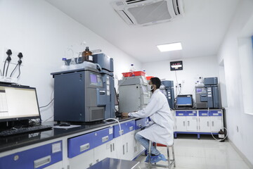 science laboratory with hplc, spectrometer, gc, uv, ir in background. hi tech latest machines and...