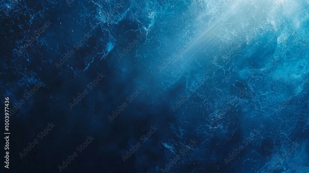 Poster ray of light is illuminating the deep blue ocean water from above, creating abstract shapes and patt