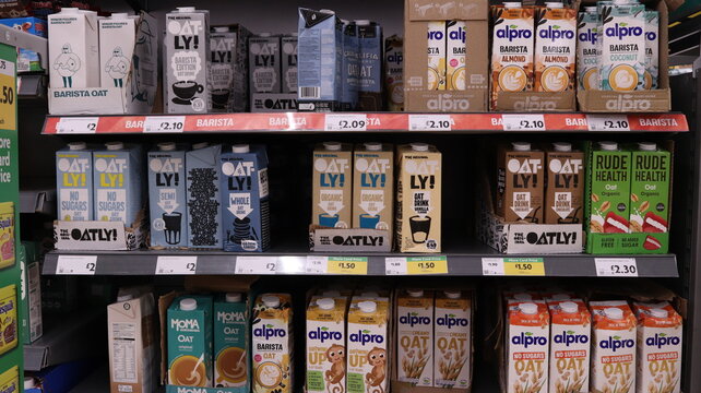 PORTH, MID GLAMORGAN, WALES, UK - SEPTEMBER 30, 2024: BRITISH SHOP MORRISONS VEGAN MILK ALTERNATIVES ON SHELVES DISPLAY ALPRO OATLY