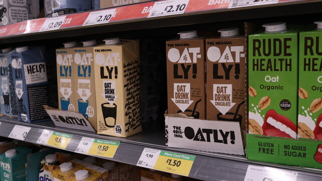 PORTH, MID GLAMORGAN, WALES, UK - SEPTEMBER 30, 2024: BRITISH SHOP MORRISONS VEGAN MILK ALTERNATIVES ON SHELVES DISPLAY ALPRO OATLY