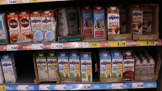 PORTH, MID GLAMORGAN, WALES, UK - SEPTEMBER 30, 2024: BRITISH SHOP MORRISONS VEGAN MILK ALTERNATIVES ON SHELVES DISPLAY ALPRO OATLY