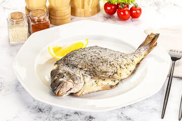 Baked Dorado fish served lemon