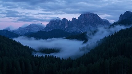 The mountains are covered in fog and the sky is a beautiful shade of blue