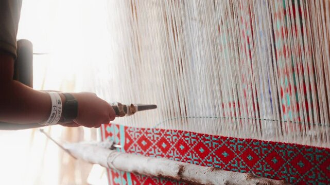 Hand loom, ancient carpets production technique. Working on a handloom, a man using a handloom to create for traditional Persian carpet in Iran village. High quality Super Slow Motion 4K video