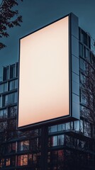 A blank billboard on the street at night.