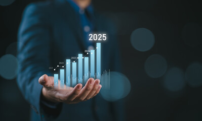 Businessman holding glowing virtual technical graph and chart for analysis stock market in 2025,...
