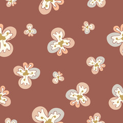 A cute seamless floral pattern with hand-drawn orchids on a pastel brown background