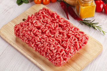 Raw minced beef meat over board