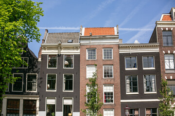 Boats and buildings along the populated canals of Amsterdam