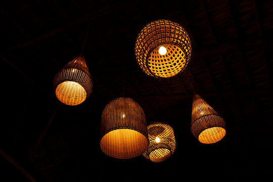 Warm lighting from wicker lamps in a tropical resort