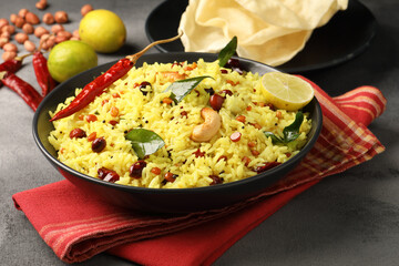 Lemon Rice or fodnicha bhat is South Indian turmeric rice or maharashtrian recipe using rice garnished with nuts curry leaves and lemon juice