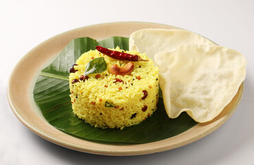 Lemon Rice or fodnicha bhat is South Indian turmeric rice or maharashtrian recipe using rice garnished with nuts curry leaves and lemon juice