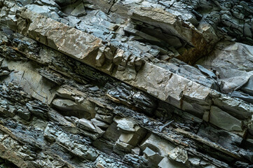 Natural stone wall. Rocky slate erosion background. Stone texture backdrop for design. Rock...