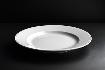 A white empty plate on a black background