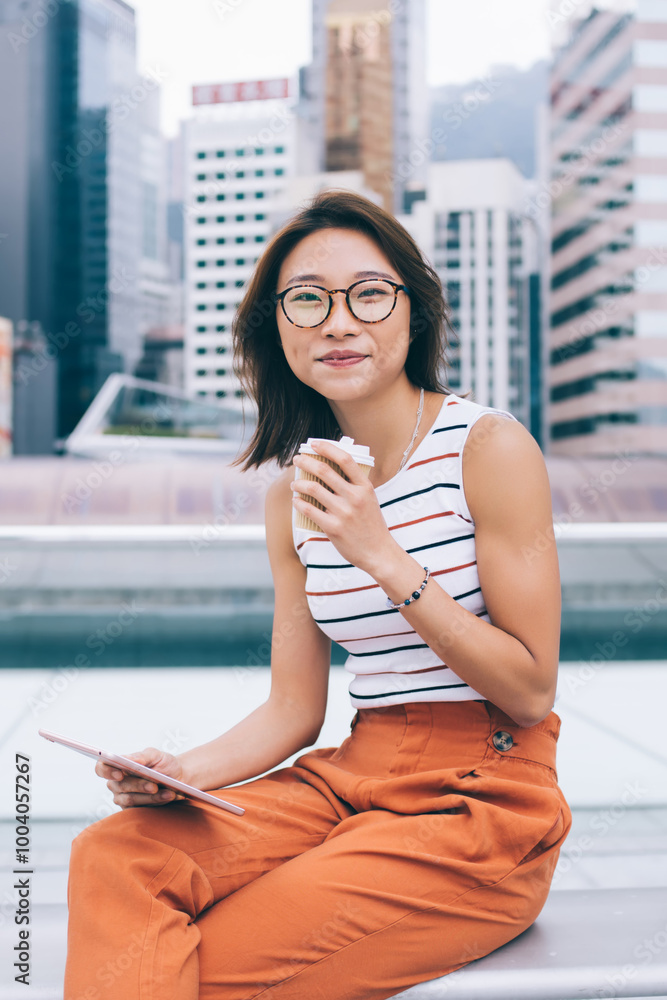 Poster portrait of chinese female blogger with digital tablet for networking in hand looking at camera and 