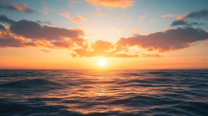 Obraz premium A stunning sunset paints the sky over the ocean. Colorful clouds drift across the horizon as the sun dips below the waves, creating a beautiful and awe-inspiring sight.