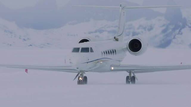 Airplane landing on snowy Antarctic runway amid breathtaking icy landscape