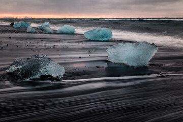 ice floes on the black sea sand and the coast Jokulsarlon