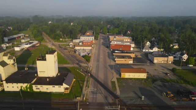 Aerial view of Monroe Street in Carleton, Michigan with grain elevators and train tracks