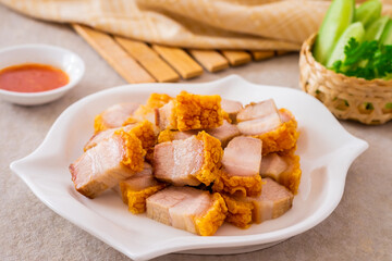Crispy pork belly on white plate and dipping sauce