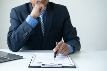 Executive CEO businessman checking job applicant documents resumes, interviews, and signing to approve the contract in the office room