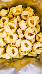 Cheese-filled pasta from Italian cuisine in the kitchen with isolated white background 