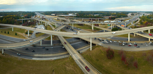Aerial view of american freeway intersection with fast moving cars and trucks. USA transportation...