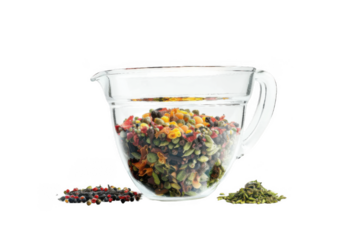 A glass measuring cup filled with colorful spices, isolated on png transparent background