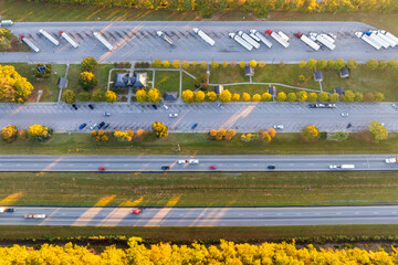 Aerial view of truck stop rest area near busy American interstate freeway. Recreational place...