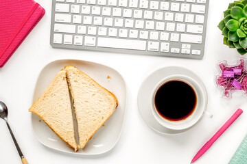 lunch in office with coffee and sandwich on white background flat lay