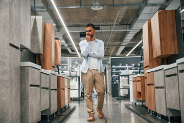 Furniture and cabinets. Man is in the hardware shop