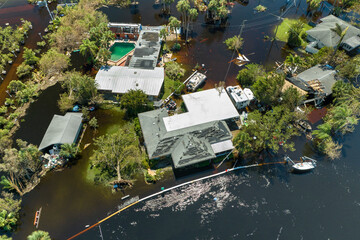 Naklejka premium Flooded houses by hurricane Ian rainfall in Florida residential area. Consequences of natural disaster