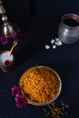 An Indian traditional snack food consisting of small pieces of crunchy noodles made from chickpea flour paste.