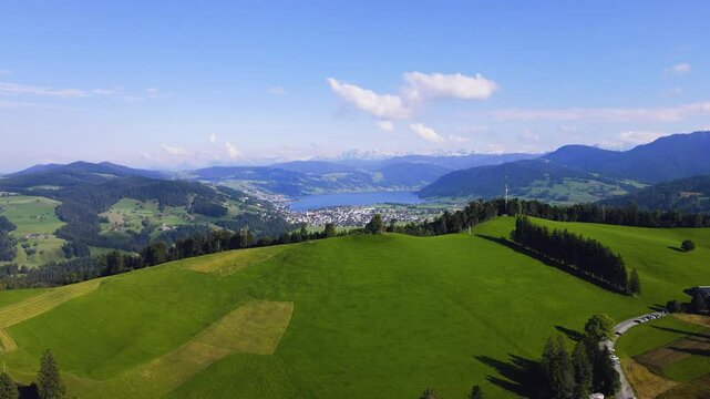 spectacular cinematic shot of Swiss lake with snow-capped Alps in the background featuring Lake Aegeri in the canton of Zug in Switzerland