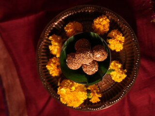 Sesame seeds laddu on the green leaf 