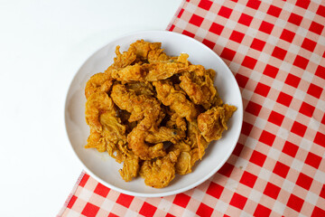 Crispy shrimp served on a plate with a red and white patterned napkin