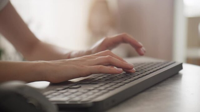 Hands Typing on Wireless Keyboard in Home Office Setting
