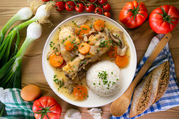 Chicken thigh stew with vegetables and rice.Top view table with  decoration.
