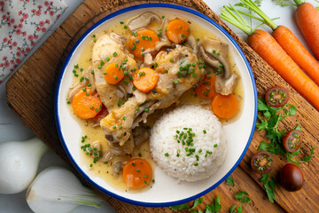 Chicken thigh stew with vegetables and rice.Top view table with  decoration.