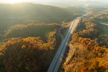 View from above of parking rest area for cars and trucks near busy American highway with fast...