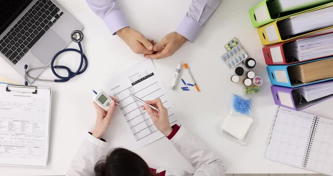 Doctor checking patient blood sugar level in clinic