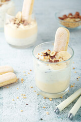 Milk mousse dessert with nuts in glasses
