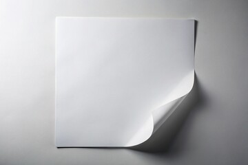 Overhead aerial view of a white paper with a raised corner