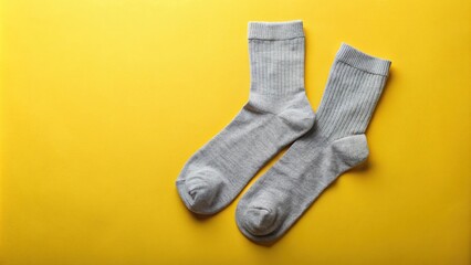 Pair of gray socks on colored background High Angle
