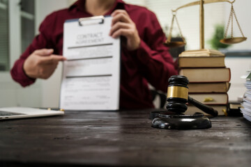 A male lawyer is working at his desk on an online judicial review, focusing on justice, fairness, and legal compliance.He reviews cases, contracts, and legal matters based on general law principles