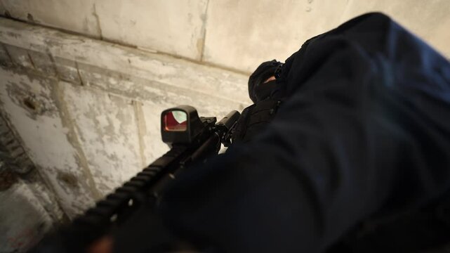 Tactical soldier with rifle in abandoned building