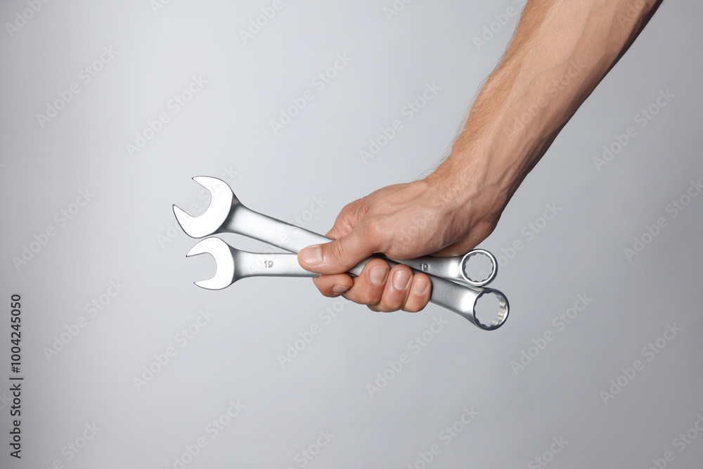 Canvas Prints Auto mechanic with wrenches on grey background, closeup