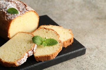 Freshly baked sponge cake on light grey table, closeup